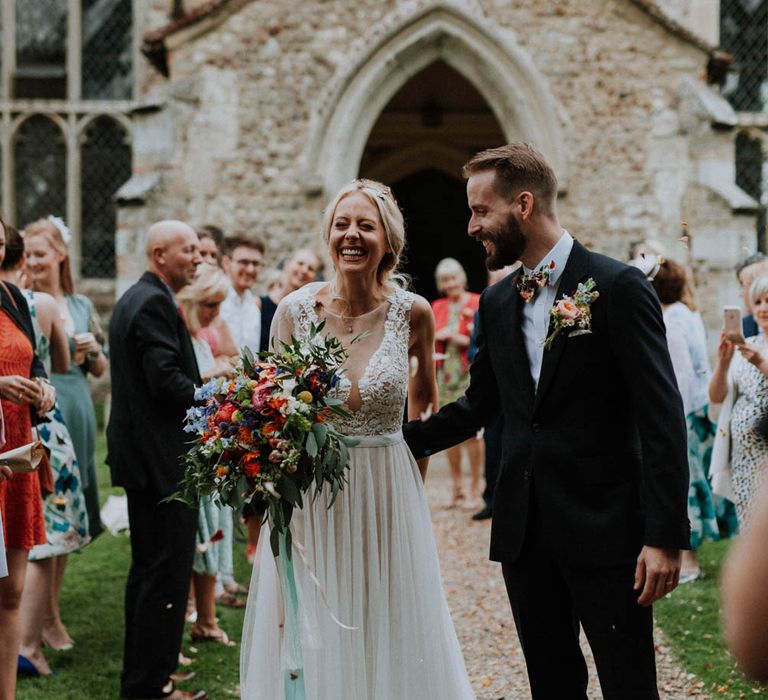 Confetti Exit | Bride in Lace & Tulle Gown | Groom in Black Suit & Liberty Print Bow Tie | Colourful DIY Barn Wedding at The Manor Barn, Cambridge | Meghan Lorna Photography