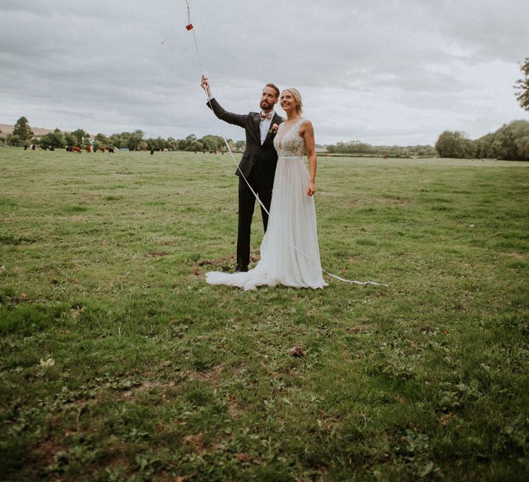 Giant Balloons | Bride in Illusion Lace & Tulle Wedding Dress | Groom in Bow Tie | Colourful DIY Barn Wedding at The Manor Barn, Cambridge | Meghan Lorna Photography