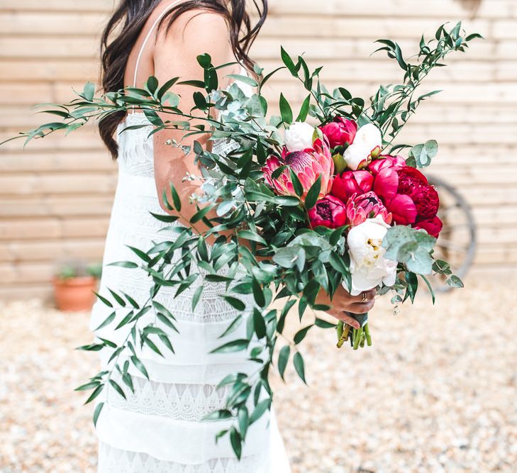 Oversized Peony & Protea Bouquet with Foliage | PapaKåta Sperry Tent at Chafford Park in Kent Countryside | Eve Dunlop Photography | Roost Film Co.