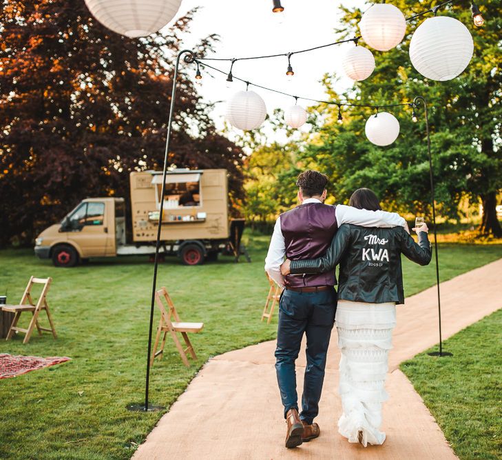 Bride in Self Portrait Dress & Personalised Leather Jacket | Groom in Navy Suit | PapaKåta Sperry Tent at Chafford Park in Kent Countryside | Eve Dunlop Photography | Roost Film Co.