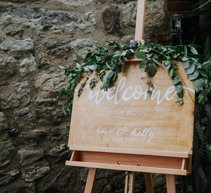 Wooden Welcome Sign with Greenery | | Cooling Castle Barn Wedding | Michelle Cordner Photography