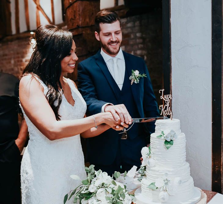 Cutting The Cake | Bride in Lace Mori Lee Gown | Groom in Ted Baker Suit | Cooling Castle Barn Wedding | Michelle Cordner Photography