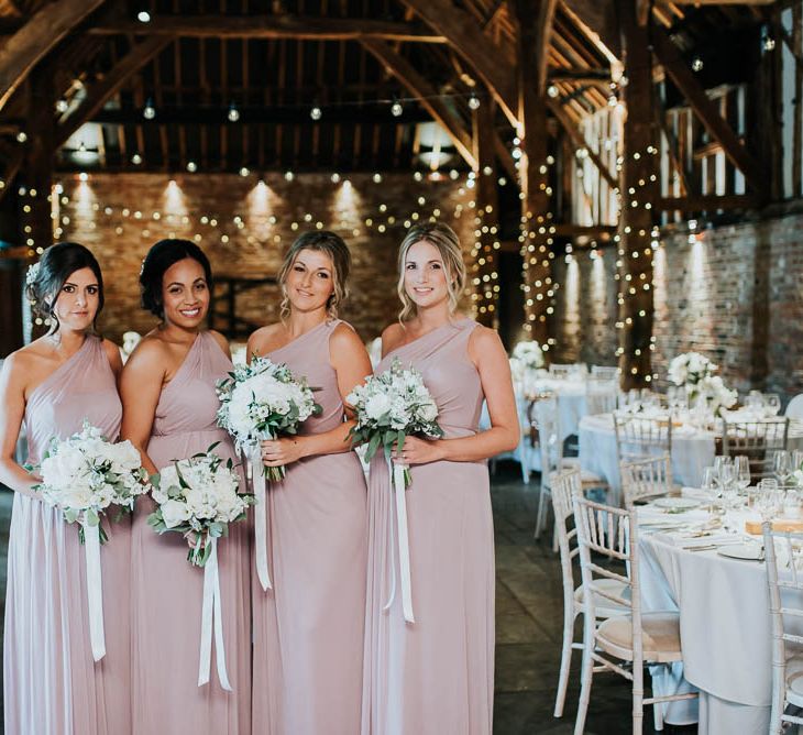 Bridesmaids in Dusky Pink One Shoulder Dresses from Davids Bridal | Cooling Castle Barn Wedding | Michelle Cordner Photography