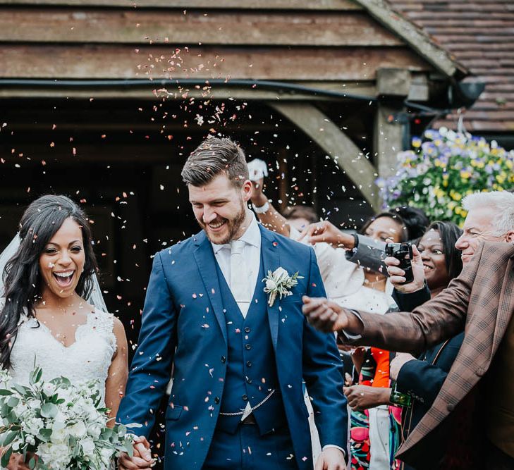 Confetti Moment | Bride in Mori Lee Gown | Groom in Ted Baker Suit from Moss Bros | Cooling Castle Barn Wedding | Michelle Cordner Photography