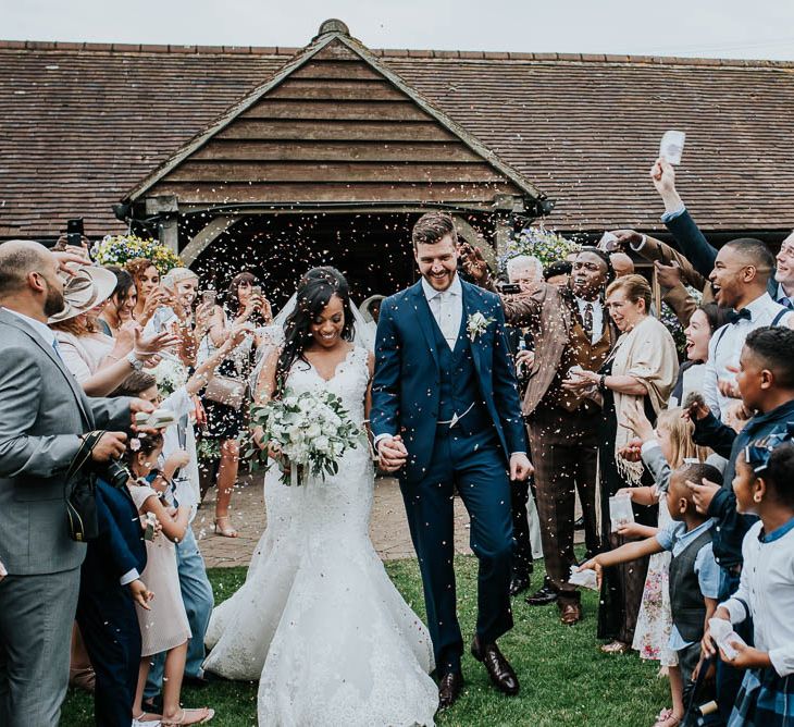 Confetti Moment | Bride in Mori Lee Gown | Groom in Ted Baker Suit from Moss Bros | Cooling Castle Barn Wedding | Michelle Cordner Photography