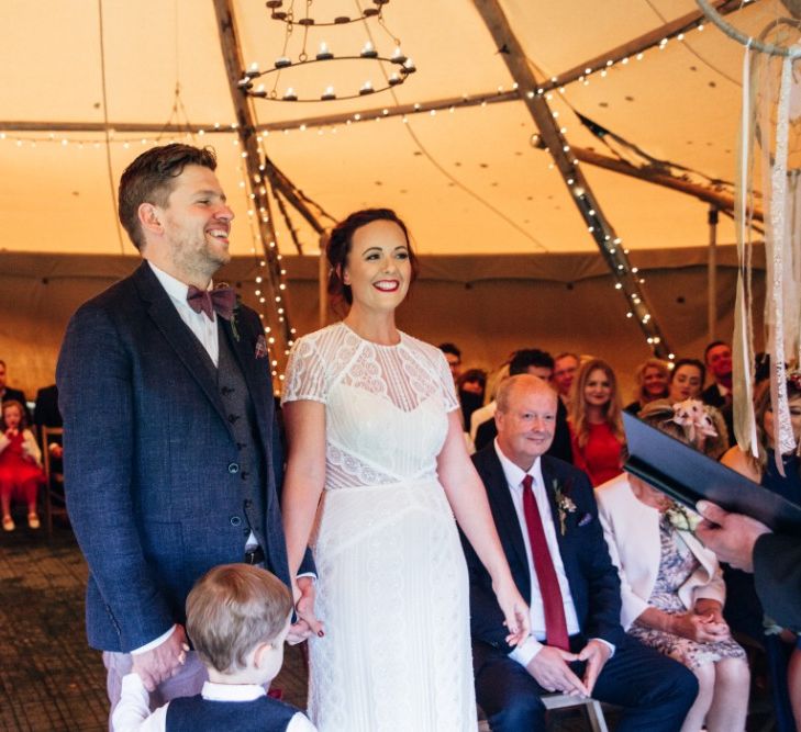 Wedding Ceremony | Bride in Lenora Watters Wtoo Lace Bridal Gown | Groom in Ted Baker Chinos & Reiss Waistcoat & Blazer | Bohemian Tipi Wedding Weekend at Fforest, Wales | Naomi Jane Photography