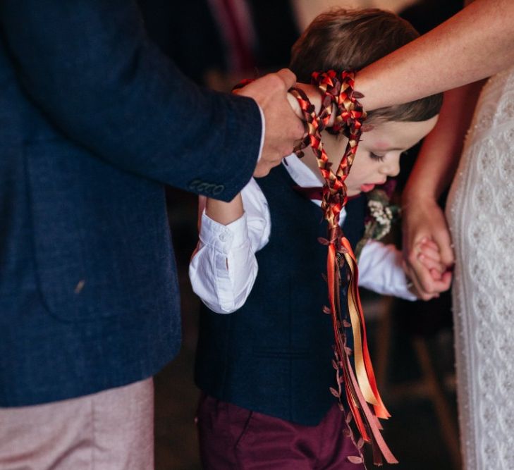 Wedding Ceremony Hand Fastening | Bride in Lenora Watters Wtoo Lace Bridal Gown | Groom in Ted Baker Chinos & Reiss Waistcoat & Blazer | Bohemian Tipi Wedding Weekend at Fforest, Wales | Naomi Jane Photography