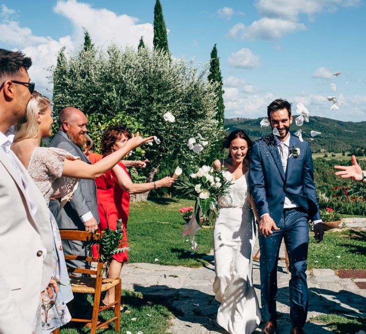 Confetti Moment | Wedding Ceremony | Sarah Seven Wedding Dress | Navy Paul Smith Suit | Outdoor Intimate Wedding at Casa Cornacchi in Tuscany, Italy | Dale Weeks Photography