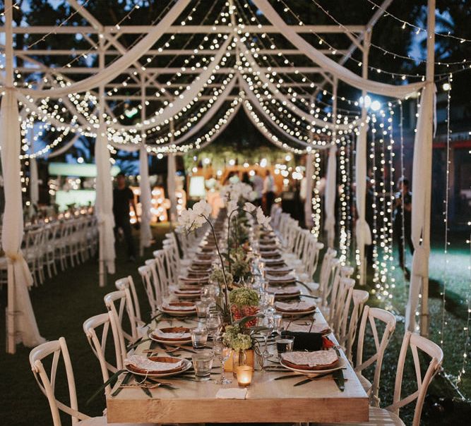 Incredible Outdoor Wedding Reception In Bali With Hanging Florals & Fairy Lights