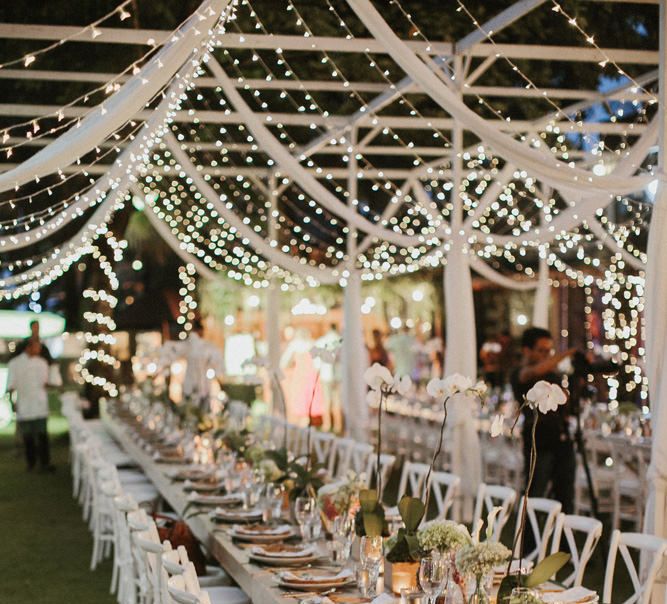 Incredible Outdoor Wedding Reception In Bali With Hanging Florals & Fairy Lights