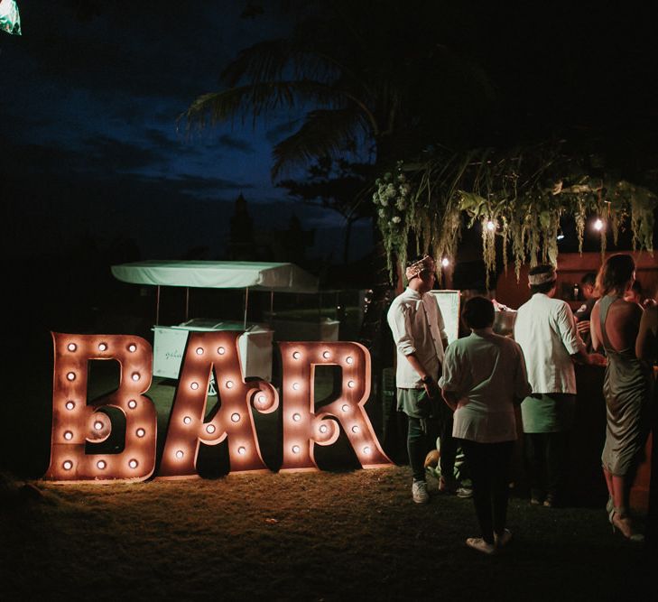 Incredible Outdoor Wedding Reception In Bali With Hanging Florals & Fairy Lights