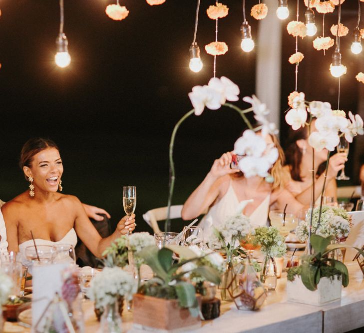 Incredible Outdoor Wedding Reception In Bali With Hanging Florals & Fairy Lights