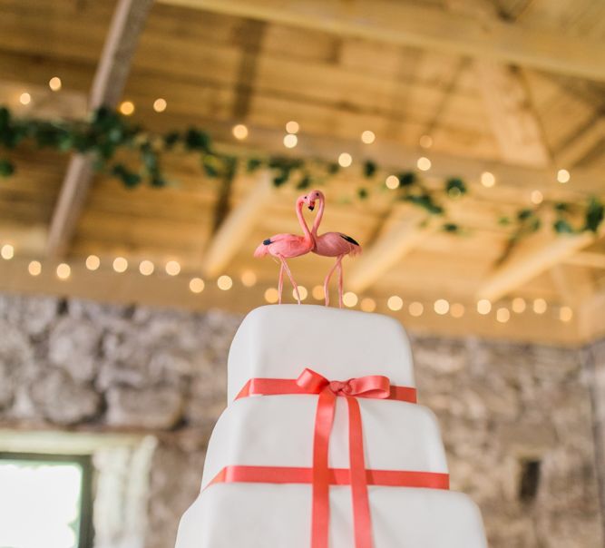 White Wedding Cake With Flamingo Cake Topper