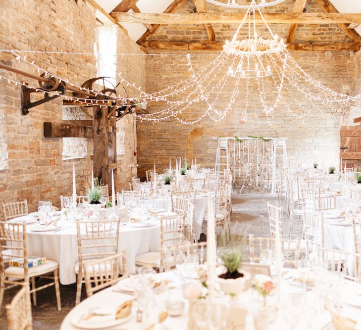 Almonry Barn Exclusive Hire Wedding Venue In Somerset With Pastel Flowers & Fairy Lights Images From Bowtie and Belle Photography With Bride In Wtoo By Watters