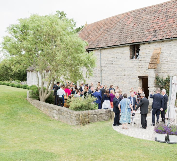 Almonry Barn Exclusive Hire Wedding Venue In Somerset With Pastel Flowers & Fairy Lights Images From Bowtie and Belle Photography With Bride In Wtoo By Watters