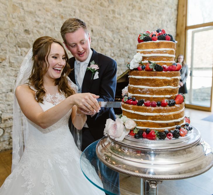 Bride & Groom Cutting the Cake | Naked Wedding Cake | Elegant Notley Abbey Wedding | Natalie J Weddings Photography