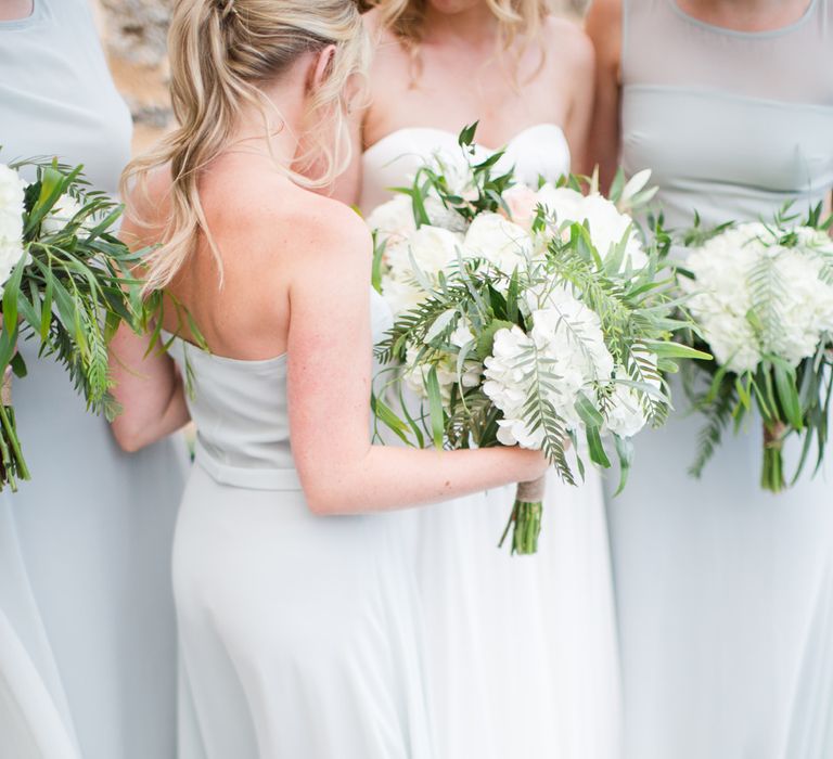 Bridesmaids in Powder Blue House of Fraser Dresses with White & Greenery Bouquets | Intimate Outdoor Destination Wedding at Kinsterna Hotel & Spa in Greece | Cecelina Photography