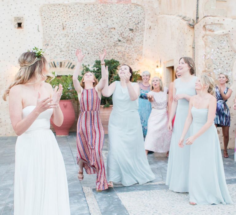 Wedding Bouquet Toss | Bride in BHLDN Gown | Intimate Outdoor Destination Wedding at Kinsterna Hotel & Spa in Greece | Cecelina Photography