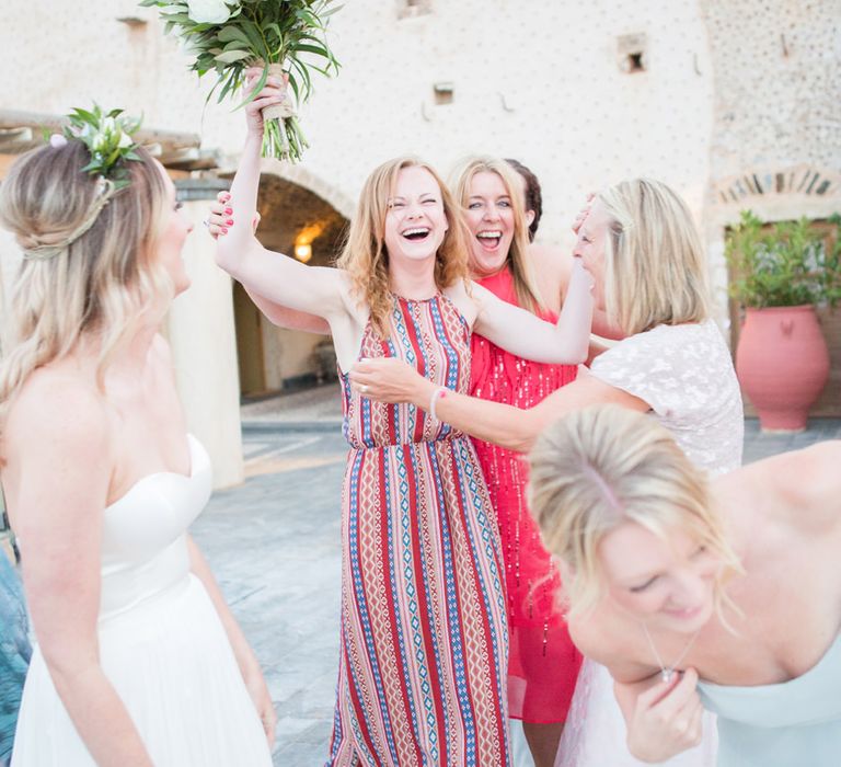 Catching the Bouquet | Intimate Outdoor Destination Wedding at Kinsterna Hotel & Spa in Greece | Cecelina Photography