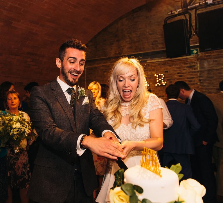 Cutting the Cake | Bride in Alice Temperley Bluebell Gown | Groom in Reiss Suit | Stylish London Wedding at Kachette | Eclection Photography