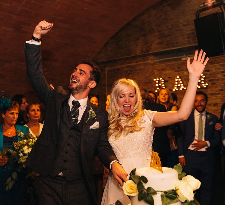 Cutting the Cake | Bride in Alice Temperley Bluebell Gown | Groom in Reiss Suit | Stylish London Wedding at Kachette | Eclection Photography