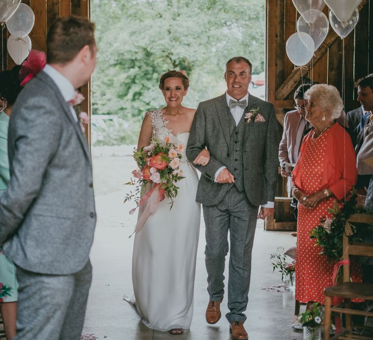 Wedding Ceremony | Bridal Entrance in Anna Campbell Gown from Coco & Kate Boutique | Coral Wedding Cake with Peony Decor | Bride in Anna Campbell Gown from Coco & Kate Boutique | Groom in Next Wool Suit | Rustic Barn Pink Summer Wedding at Nancarrow Farm in Cornwall | Ross Talling Photography