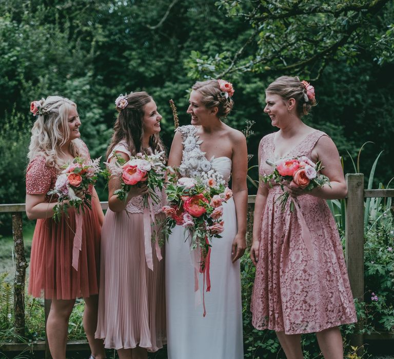 Bridesmaids in Highstreet Pink Dresses | Bride in Anna Campbell Gown from Coco & Kate Boutique | Rustic Barn Pink Summer Wedding at Nancarrow Farm in Cornwall | Ross Talling Photography