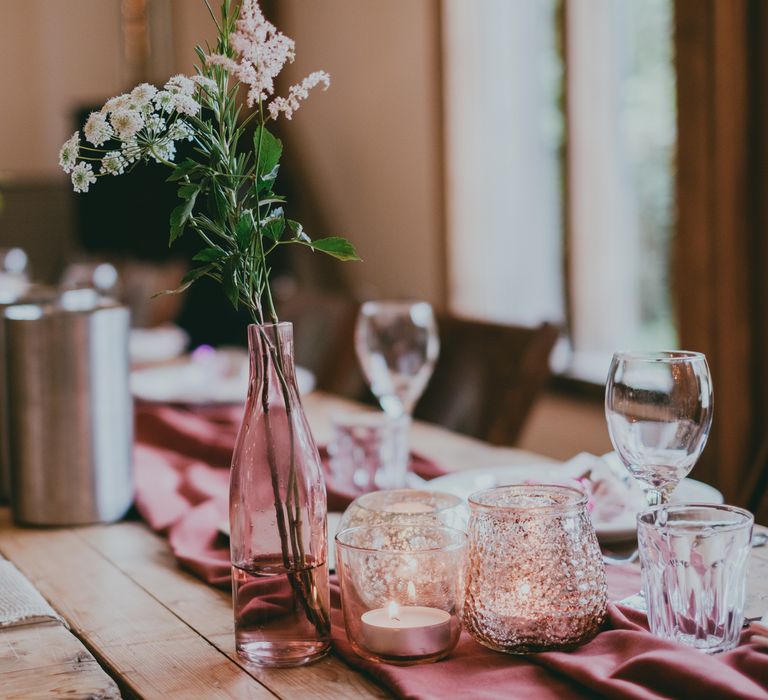 Pink Bottle with Flower Stem | Bride in Anna Campbell Gown from Coco & Kate Boutique | Groom in Next Wool Suit | Rustic Barn Pink Summer Wedding at Nancarrow Farm in Cornwall | Ross Talling Photography