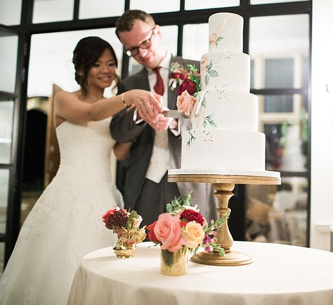 Cutting the Cake | Bride in Renee L. Collections Gown | Groom in Moss Bros Traditional Suit | Jacob & Pauline Photography | Pretty in White Films