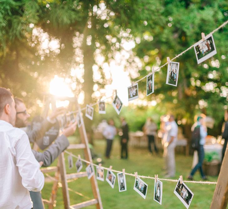 Strung up Polaroid Pictures Wedding Decor