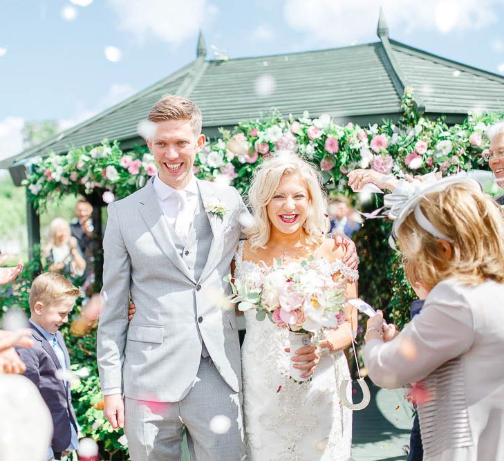 Confetti Exit | Bride in Sottero & Midgley Gown | Groom in Grey Reiss Suit | The Secret Garden Wedding Venue in Essex | White Stag Wedding Photography