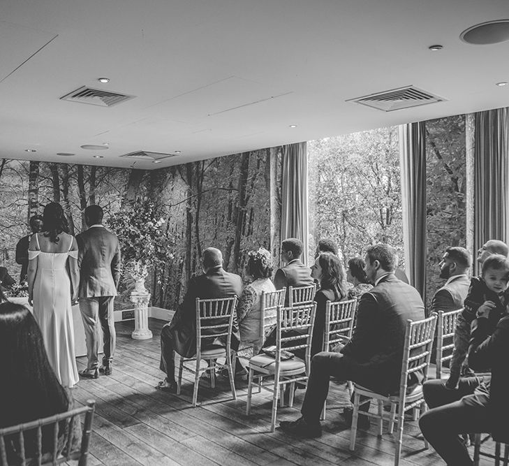 Wedding Ceremony | Bride in Reformation Poppy Gown | Groom in Navy Bespoke Club Suit | Stylish London Wedding Planned by Revelry Events | Story + Colour Photography