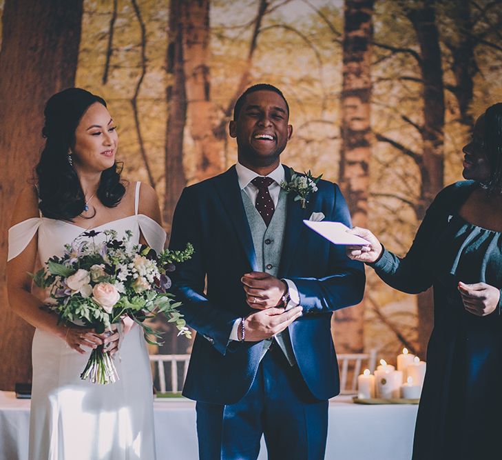 Wedding Ceremony | Bride in Reformation Poppy Gown | Groom in Navy Bespoke Club Suit | Stylish London Wedding Planned by Revelry Events | Story + Colour Photography