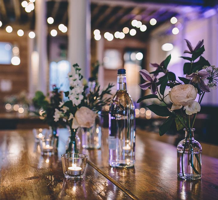 Festoon Lights | Flower Stems in Bottles | Wedding Decor | Stylish London Wedding Planned by Revelry Events | Story + Colour Photography