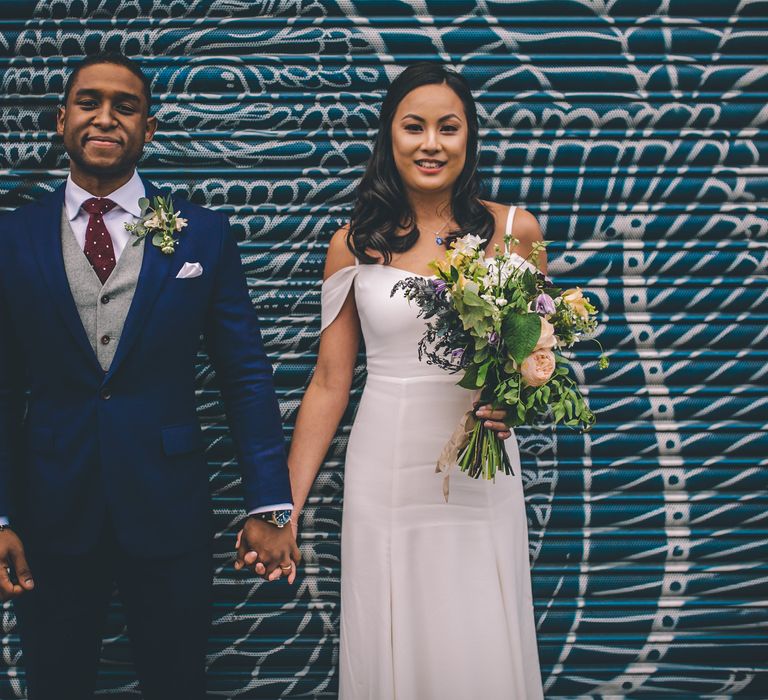 Bride in Reformation Poppy Gown | Groom in Tailored The Bespoke Club Navy Suit | Stylish London Wedding Planned by Revelry Events | Story + Colour Photography