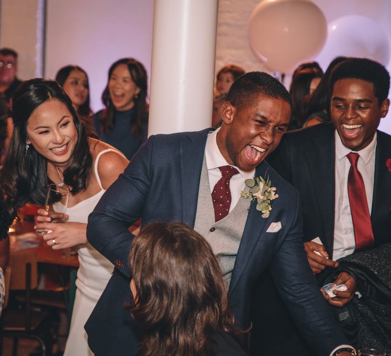 Bride in Reformation Poppy Gown | Groom in Tailored The Bespoke Club Navy Suit | Stylish London Wedding Planned by Revelry Events | Story + Colour Photography