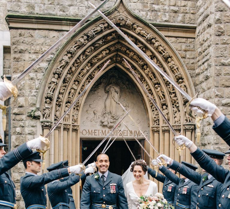 Guard of Honour with Bride in Charlotte Simpson Wedding Dress & Groom in Military Uniform