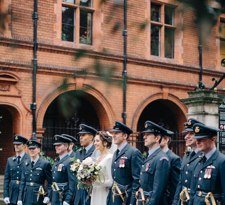 Bride in Charlotte Simpson Wedding Dress & Groom in Military Uniform