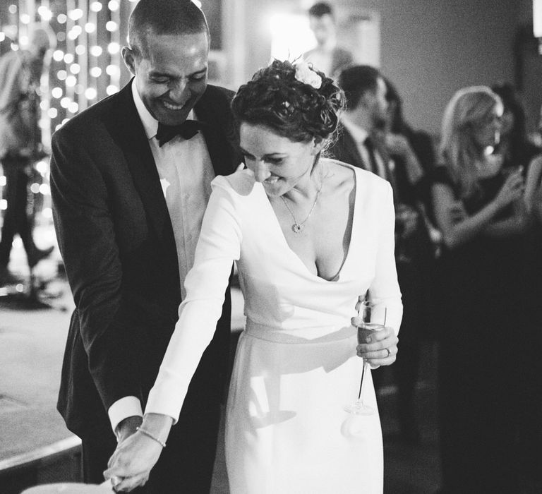 Cutting the Cake with Bride in Charlotte Simpson Wedding Dress & Groom in Tuxedo