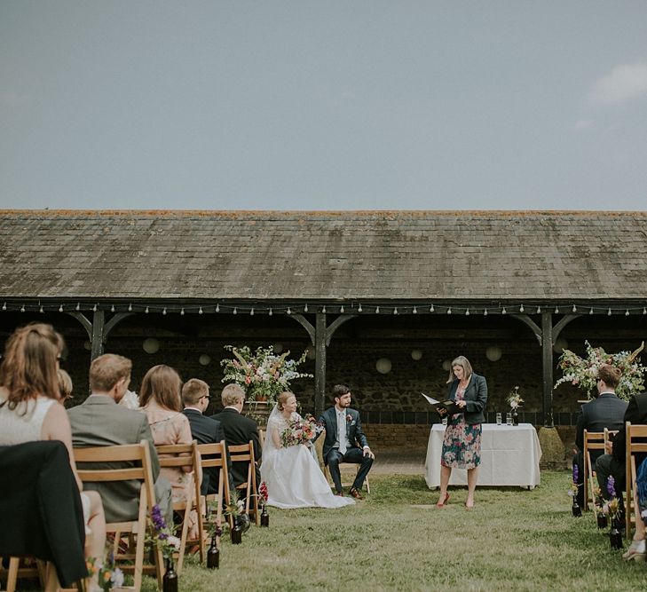 Outdoor Wedding Ceremony at Elmley Nature Reserve | Bride in Alice Temperley Gown | Groom in Edit Suits Co | Lola Rose Photography