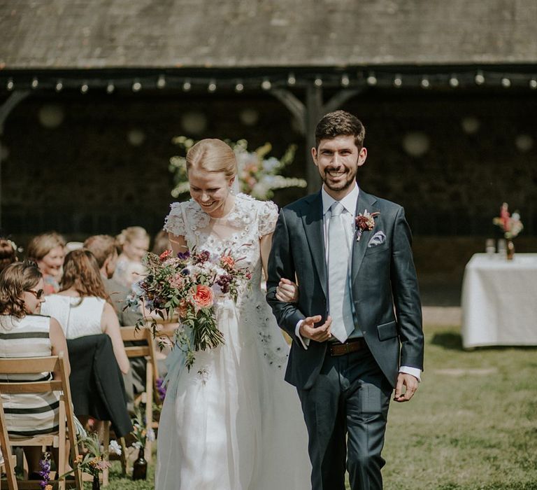 Outdoor Wedding Ceremony at Elmley Nature Reserve | Bride in Alice Temperley Gown | Groom in Edit Suits Co | Lola Rose Photography