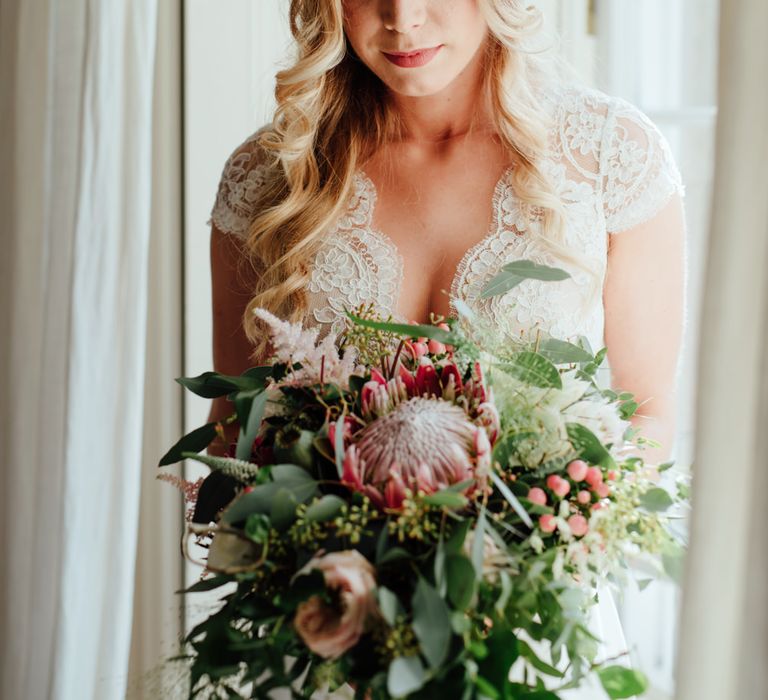 Bride in Bespoke Suzanne Neville Scarlett Bridal Gown | Protea Bouquet & Flower Crown | The Lou's Photography