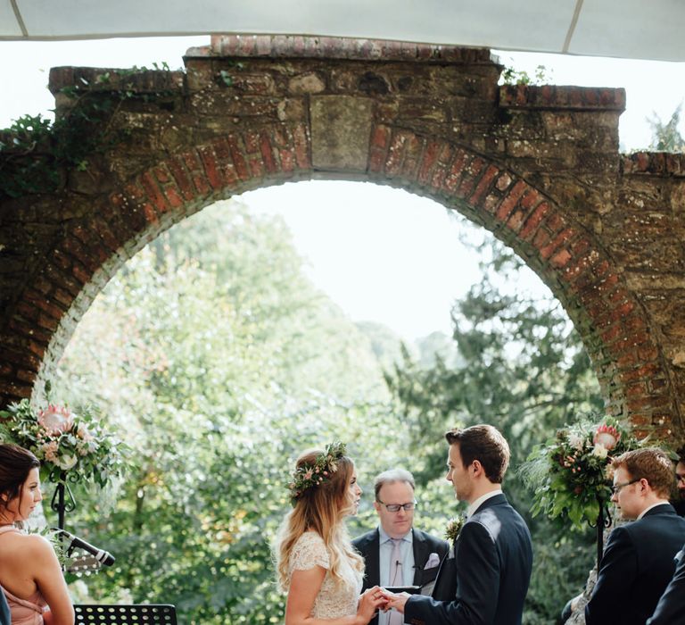 Outdoor Ceremony at Drenagh Estate in Northern Ireland | Bride in Bespoke Suzanne Neville Scarlett Bridal Gown | Protea Bouquet & Flower Crown | The Lou's Photography