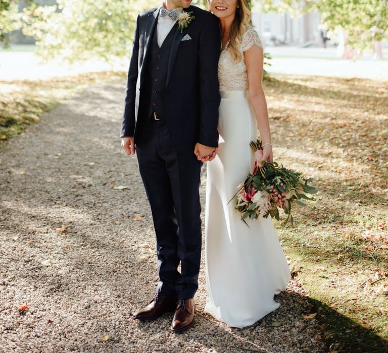 Bride in Bespoke Suzanne Neville Scarlett Bridal Gown | Groom in Herbie Frogg Suit & Liberty Print Mrs Bow Tie | The Lou's Photography