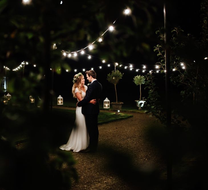 Festoon Lights | Bride in Bespoke Suzanne Neville Scarlett Bridal Gown | Groom in Herbie Frogg Suit & Liberty Print Mrs Bow Tie | The Lou's Photography