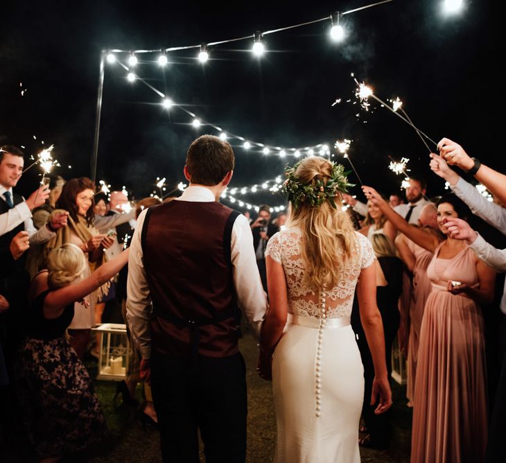 Sparkler Exit | Bride in Bespoke Suzanne Neville Scarlett Bridal Gown | Groom in Herbie Frogg Suit & Liberty Print Mrs Bow Tie | The Lou's Photography