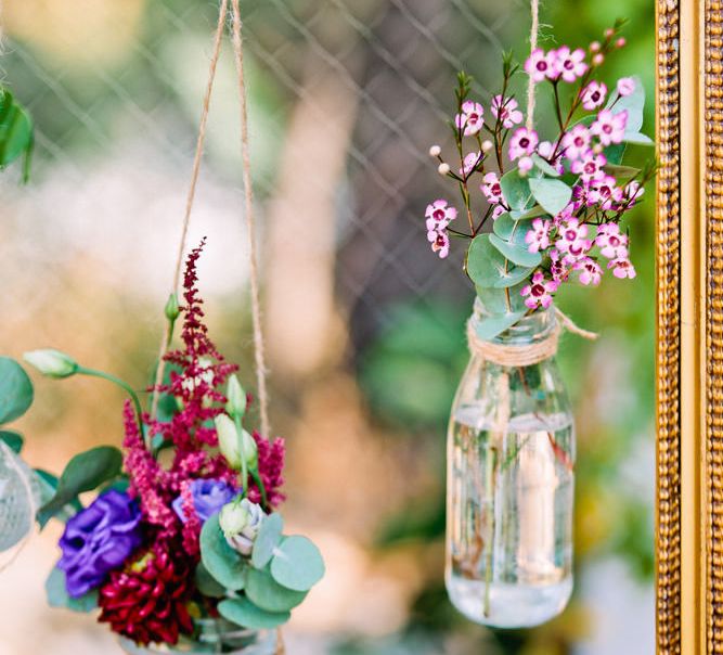 Hanging Bottles with Flowers | Wedding Decor | Jewel Coloured Spanish Wedding Planned & Styled by Rachel Rose Weddings | Anna Gazda Photography