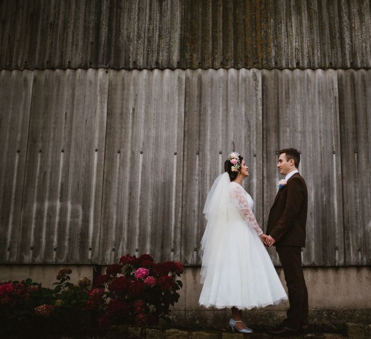 Bride in Bespoke Something Blue Tea Length Wedding Dress | Pastel Flower Crown & Bouquet | Groom in Brown Tweet Suit | Ally M Photography