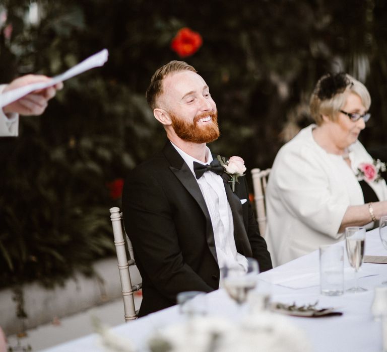 Groom in Black Tuxedo during Speeches