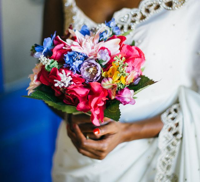 Bride In White & Gold Sari With Brightly Coloured Wedding Bouquet